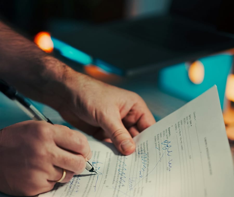 Hands signing a loan agreement