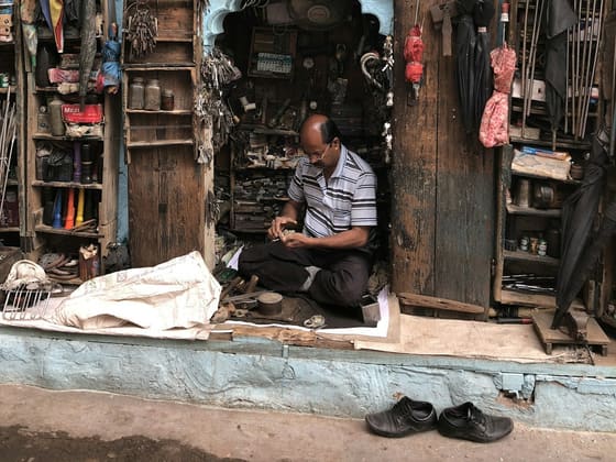An artisan working at his repair shop