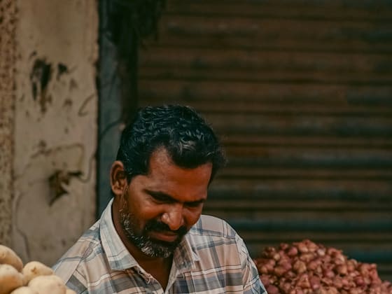 A vegetable trader at his market stall